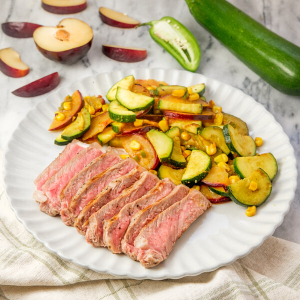 Grilled Strip Steak with Curried Corn, Zucchini & Plum Sauté