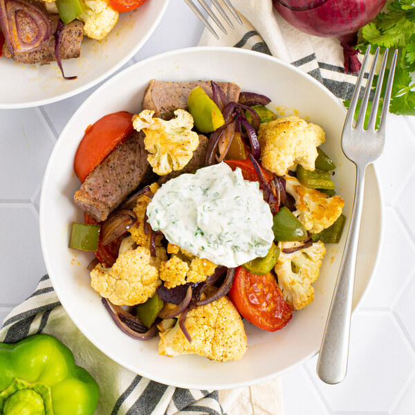 Peruvian-Style Steak, Cauliflower & Tomato Bake with Cilantro Yogurt