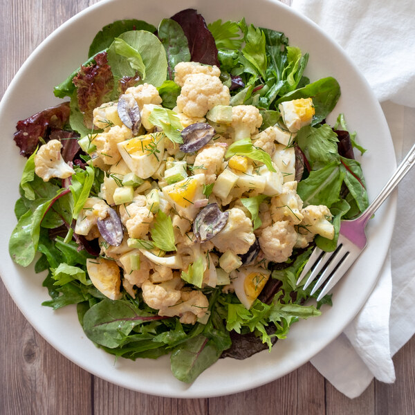 Deli Style Cauliflower, Olive & Egg Salad Over Mixed Greens