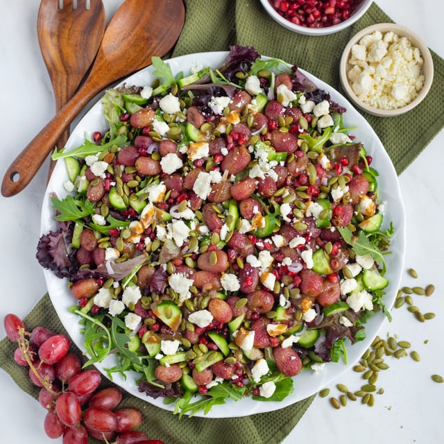 Mixed Green Salad with Roasted Red Grapes, Pomegranate Seeds & Feta