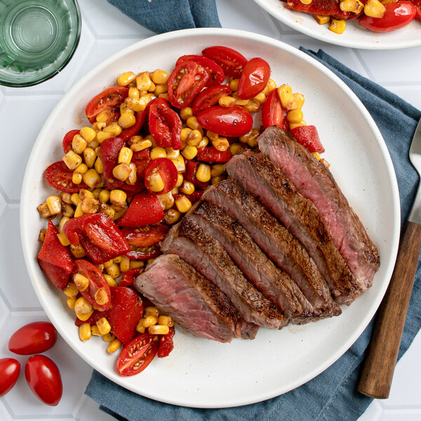 Seared Strip Steak with Cajun Corn, Tomato & Roasted Red Pepper Sauté