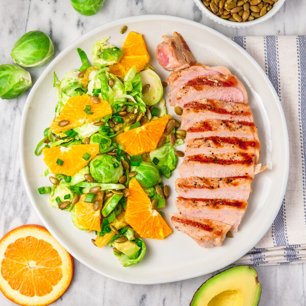 Grilled Pork Chop with Raw Brussels Sprout, Orange & Avocado Salad