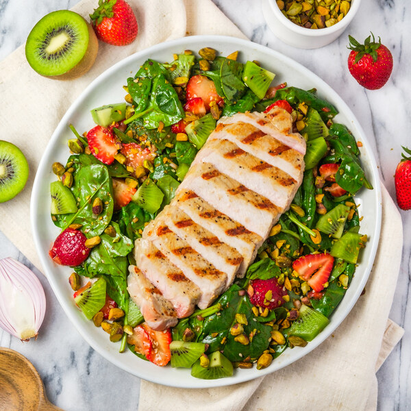 Grilled Pork Chop over Strawberry-Kiwi Spinach Salad with Pistachios